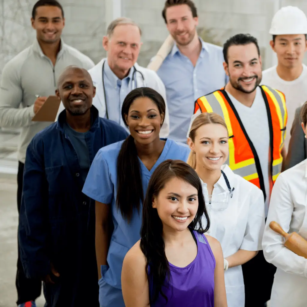 A group of diverse professionals from various industries smiling at the camera.