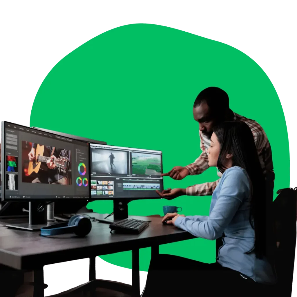 Professionals working together on computers, demonstrating our expert graphic design and visual content creation services