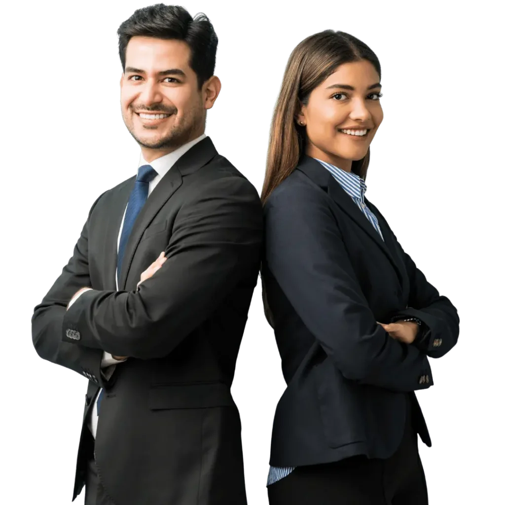 A man and a woman in professional business attire stand back-to-back with arms crossed, smiling confidently at the camera.