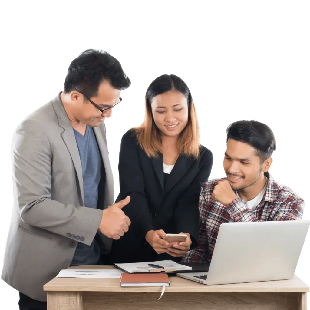 Three professionals collaborating on social media marketing strategy using a laptop and phone