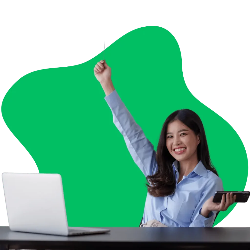 A happy woman celebrating an e-commerce SEO success with a laptop on her desk, representing e-commerce SEO optimization and growth.