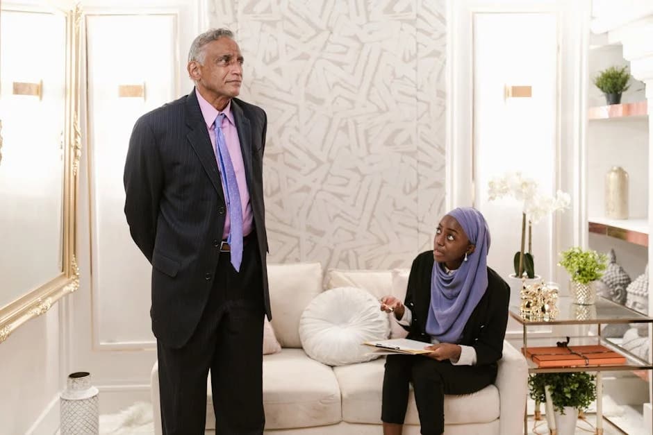 Business management consultant advising a client in a professional office setting