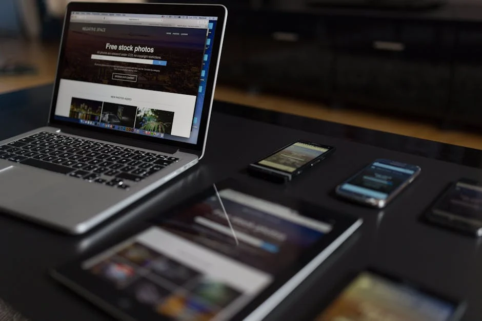 Responsive web design showcased on laptop, tablet, and smartphones displaying the same website layout across multiple devices.